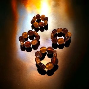 SET OF 4 GLAS NAPKIN RINGS AMBER COLORED